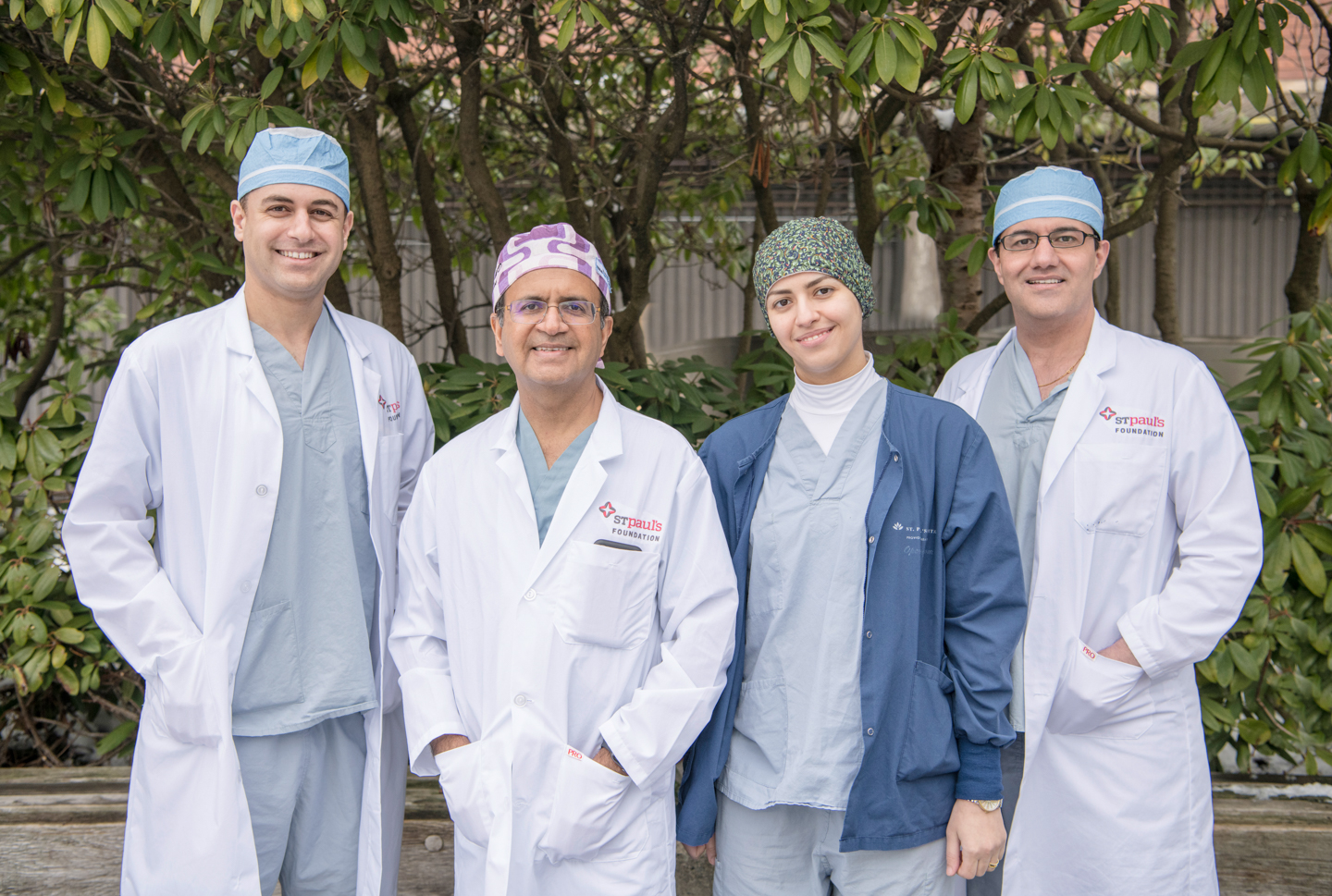 Image of Dr. Amin Javer, director of St. Paul's Sinus Centre, stand smiling with three fellows.