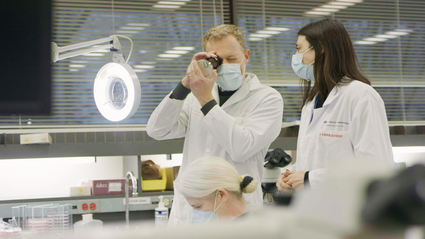 Dr. Marc Romney and a St. Paul's Hospital lab team member.