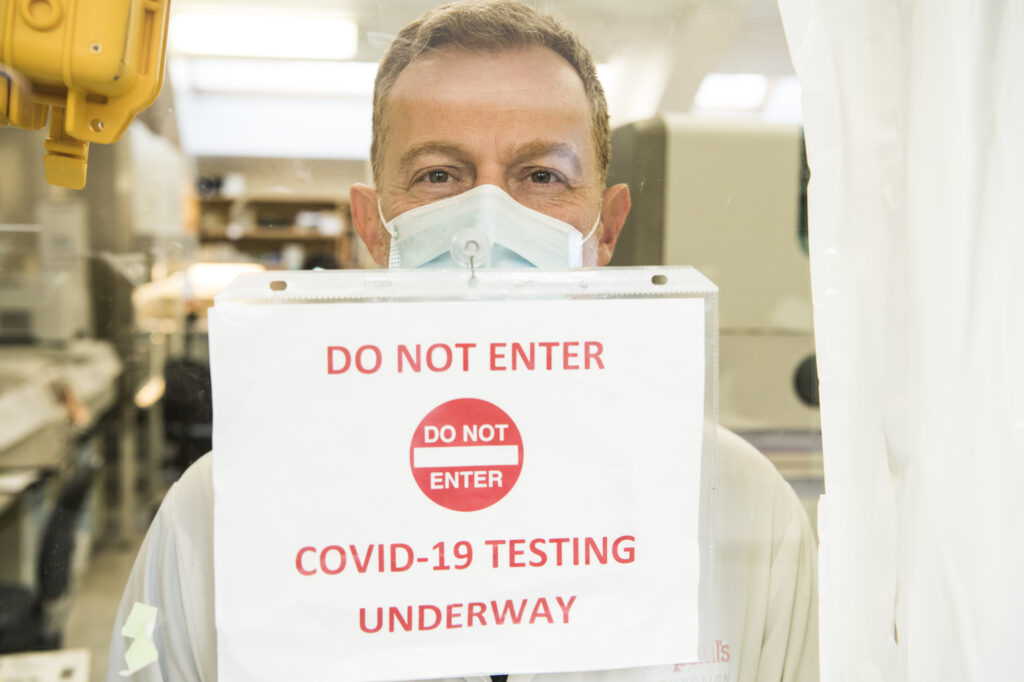 Image of Dr. Marc Romney holding up a sign