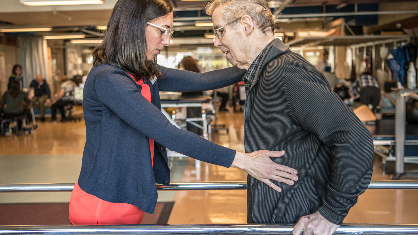 A physiotherapist supports a patient in the HFH Rehab Centre.
