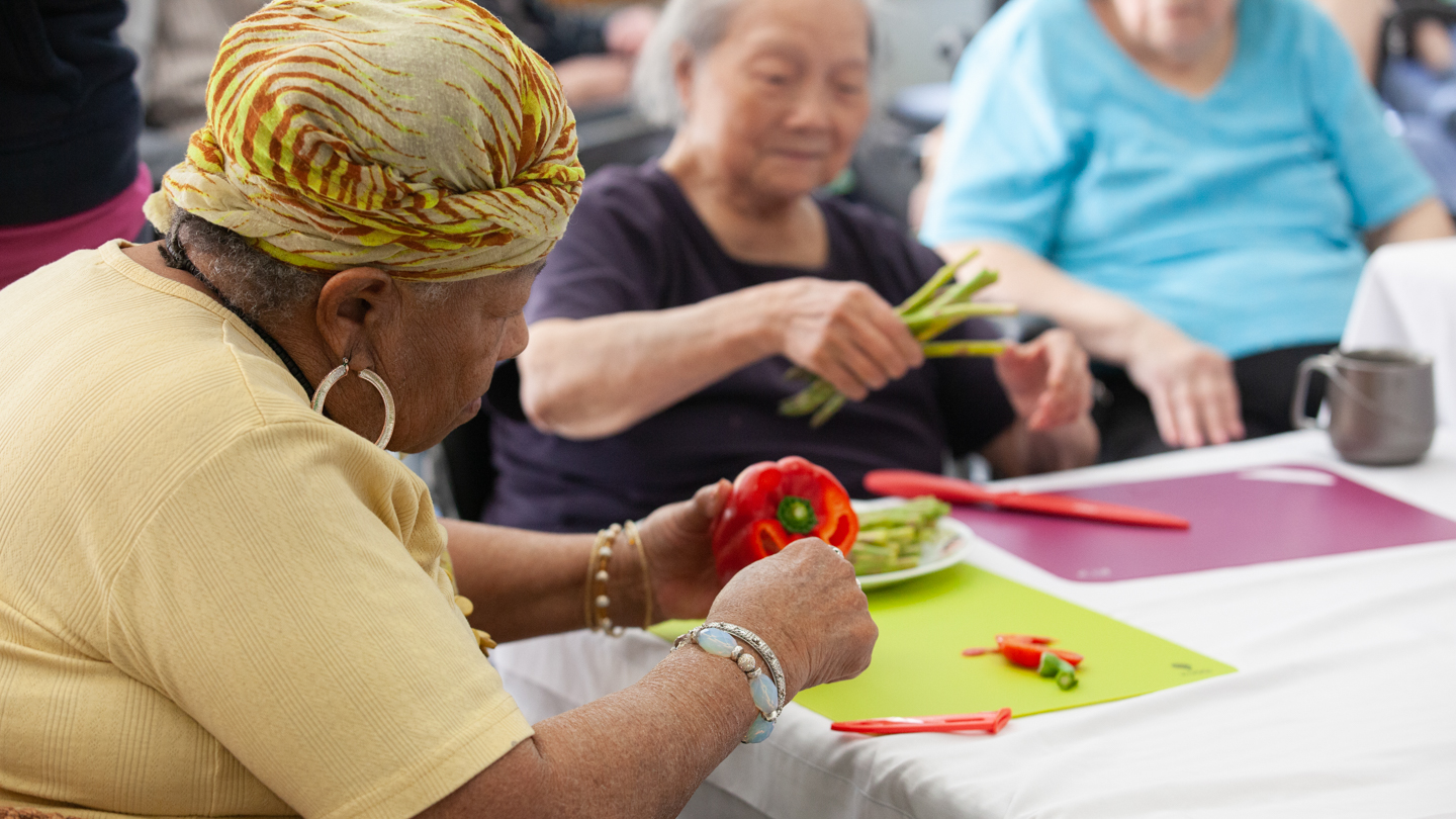 A resident participates in a cooking class at St. Vincent's: Langara.