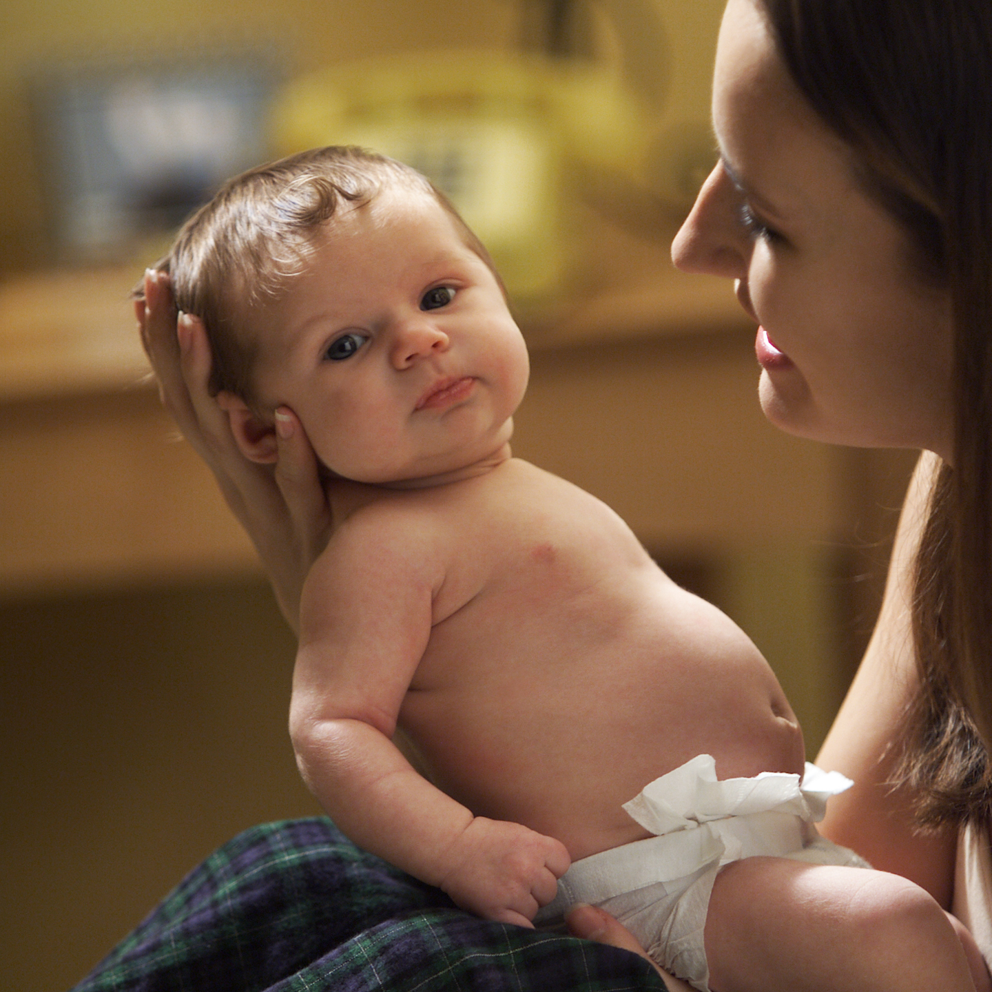 A mother holds her newborn baby.
